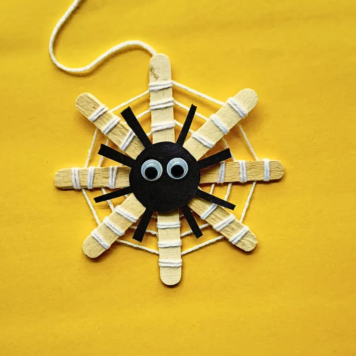 This DIY popsicle stick spider web craft is a fun preschool Halloween crat for kids. Made using 3 simple supplies, perfect for Halloween spider activities.