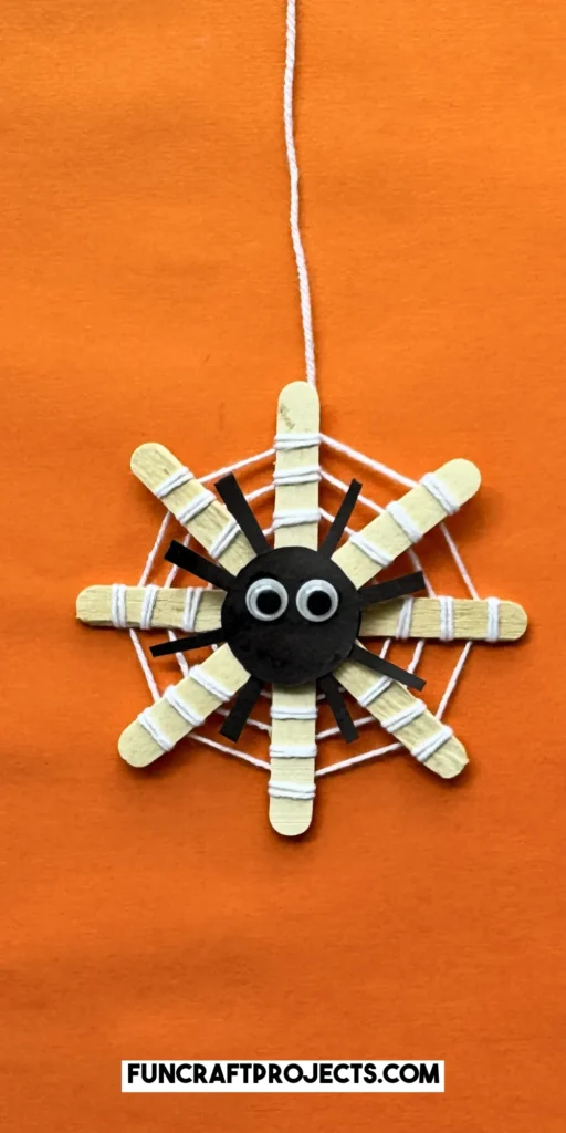 This DIY popsicle stick spider web craft is a fun preschool Halloween crat for kids. Made using 3 simple supplies, perfect for Halloween spider activities.