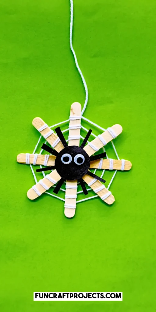 This DIY popsicle stick spider web craft is a fun preschool Halloween crat for kids. Made using 3 simple supplies, perfect for Halloween spider activities.