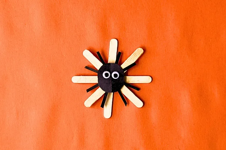 This DIY popsicle stick spider web craft is a fun preschool Halloween crat for kids. Made using 3 simple supplies, perfect for Halloween spider activities.