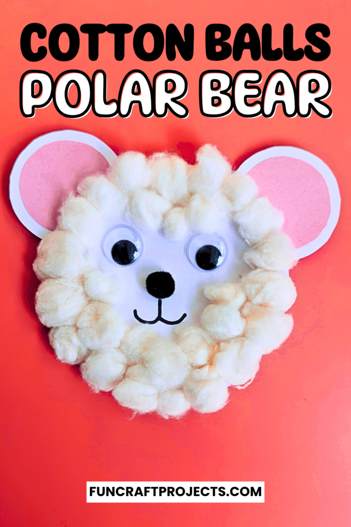 A cute cotton ball polar bear craft, white paper, and black and orange construction paper details.