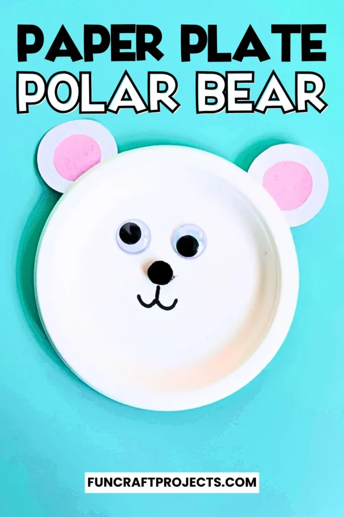 Paper plate polar bear craft with googly eyes, pink ears, and a simple black nose. Easy DIY bear craft for kids, perfect for preschool or winter activities.