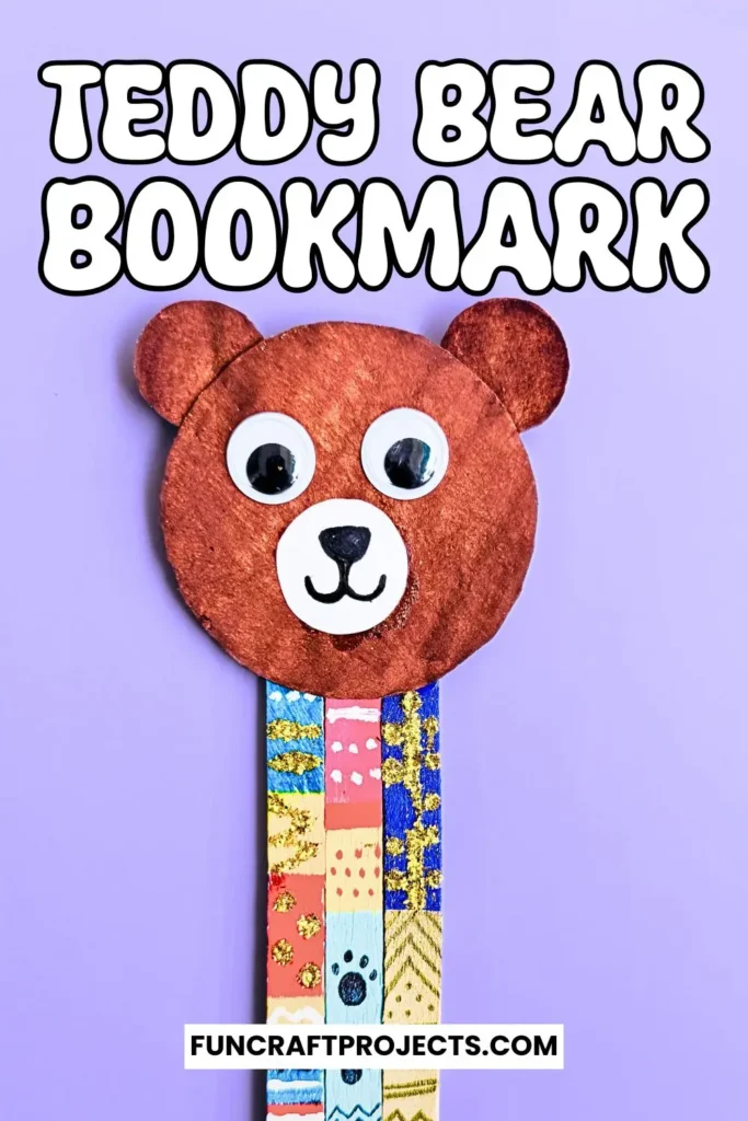 Handmade popsicle stick teddy bear bookmark craft with colorful patterns and googly eyes, crafted from jumbo popsicle sticks and brown craft paper