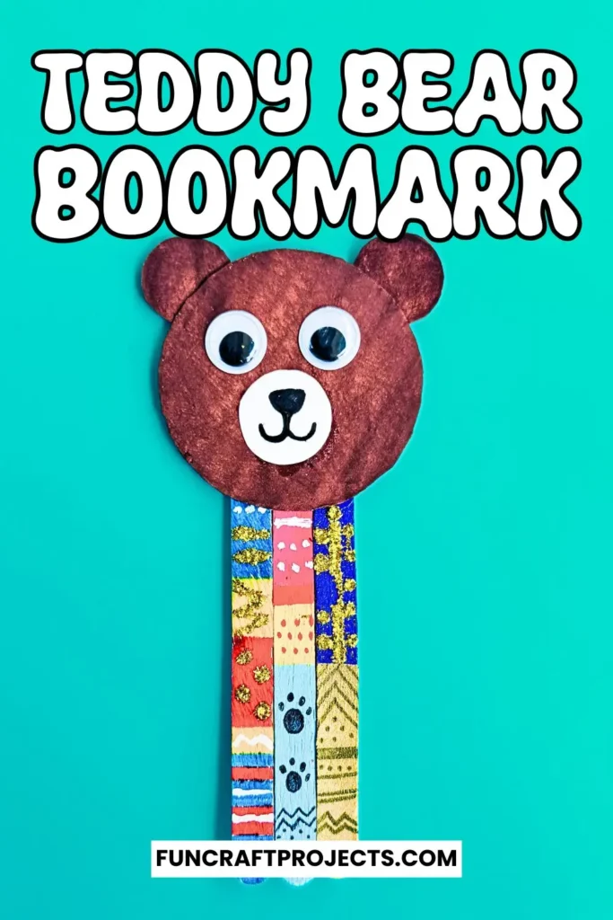 Handmade popsicle stick teddy bear bookmark craft with colorful patterns and googly eyes, crafted from jumbo popsicle sticks and brown craft paper