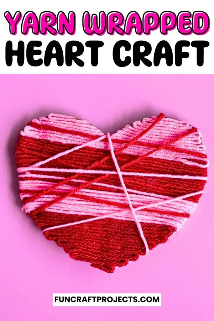 A vibrant yarn wrapped heart craft featuring pink and red yarn, wrapped intricately around a sturdy heart-shaped cardboard, perfect for Valentine’s Day.