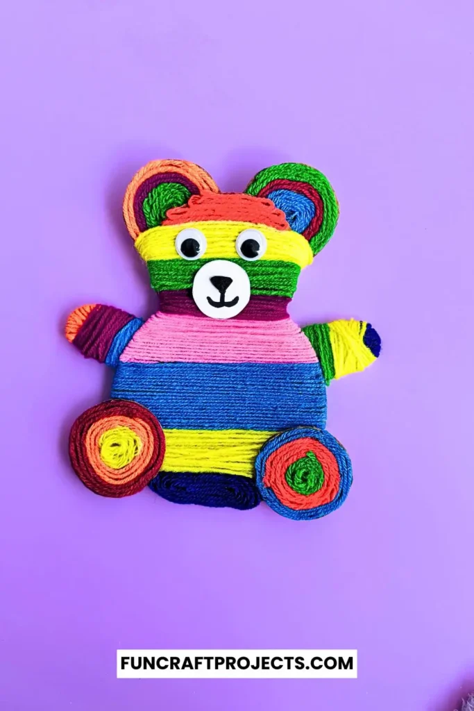 Yarn Wrapped Teddy Bear Craft with rainbow-colored yarn, googly eyes, and a cute face made from craft foam. A fun and creative craft for kids