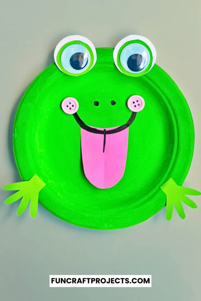 Paper Plate Frog Craft – A bright green paper plate frog with big googly eyes, a pink tongue, and cut-out hands, perfect for preschool crafts and fun activities